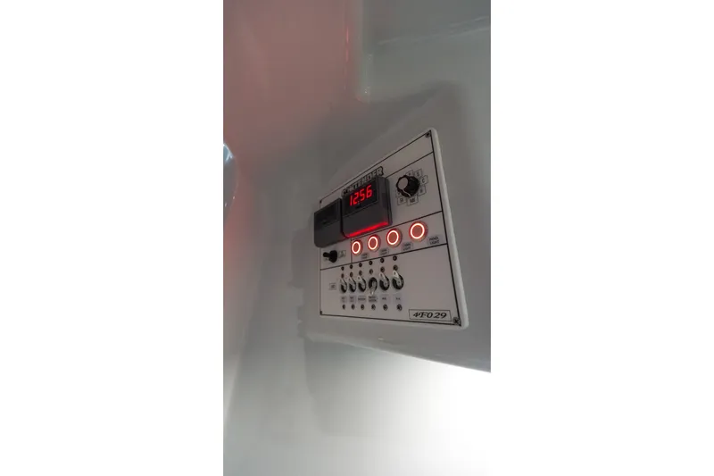 Slide: The Image of Control panel of 2024 Contender 44 Fisharound boat with illuminated buttons and display. - 68