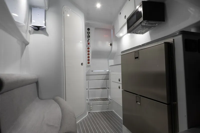 Slide: The Image of Interior of 2024 Contender 44 Fisharound boat with modern kitchen and seating area. - 17