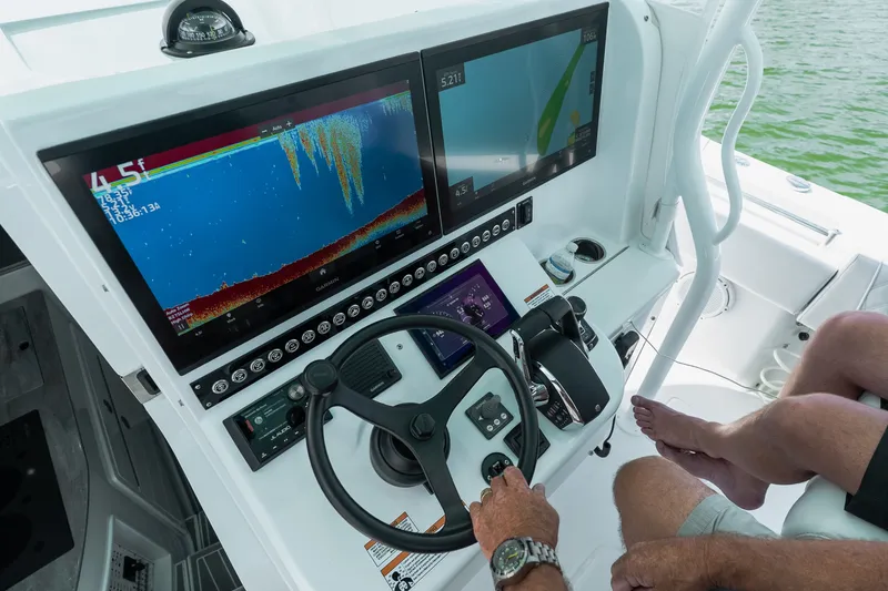 Slide: The Image of 2024 Contender 44 Fisharound helm with advanced navigation and sonar displays. - 54