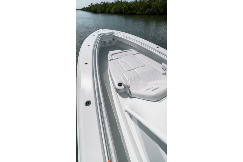 Slide: The Image of 2024 Contender 44 Fisharound boat with sleek deck design on calm water. - 61