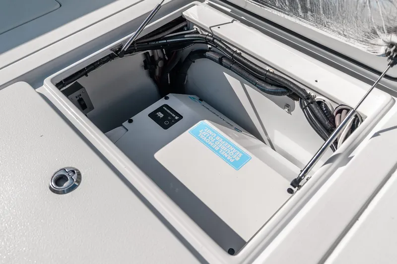 Slide: The Image of 2024 Contender 44 Fisharound boat storage compartment with power unit and wiring. - 25