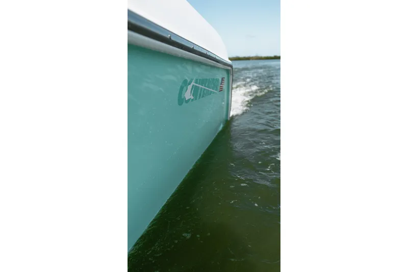 Slide: The Image of 2024 Contender 44 Fisharound boat cruising on water, side view. - 57