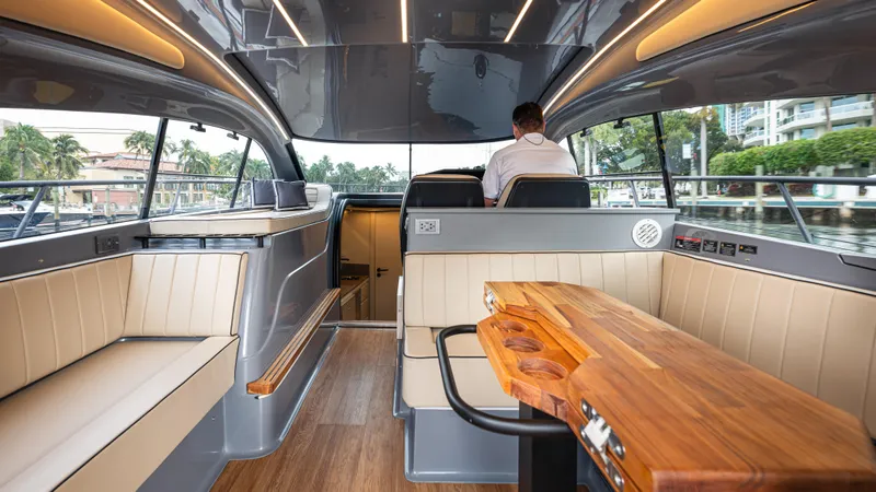 Slide: The Image of Luxurious interior of 2025 Hanover 415 yacht with modern seating and wooden table. - 18