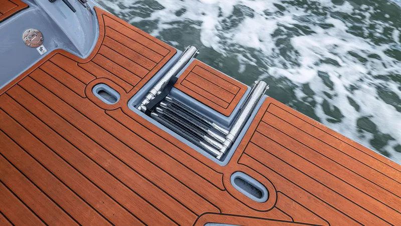 Slide: The Image of The 2027 Hanover 415 features a sleek teak deck with an integrated swim ladder at the stern. - 35