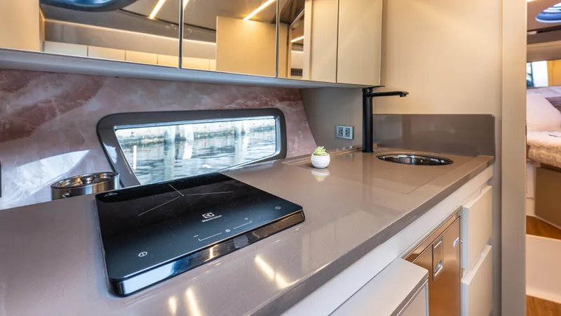 Slide: The Image of Modern kitchen interior in 2025 Hanover 415 yacht with sleek countertops and appliances. - 16