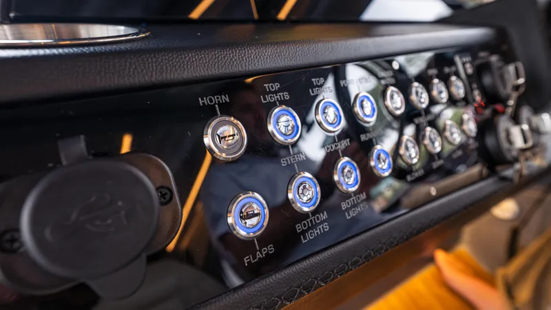Slide: The Image of Close-up of a boat control panel with various switches and buttons, including horn and lights. - 29