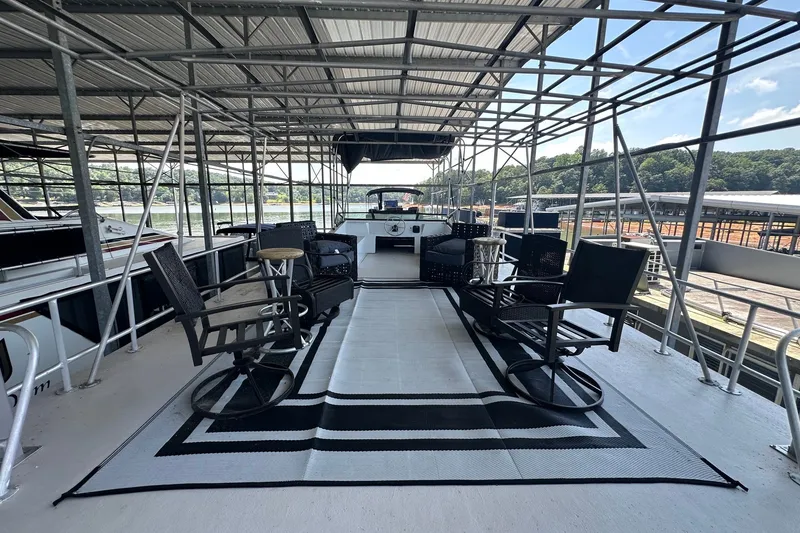 Slide: The Image of Upper deck of 1988 Stardust Cruisers 16x65 houseboat with seating and canopy. - 14