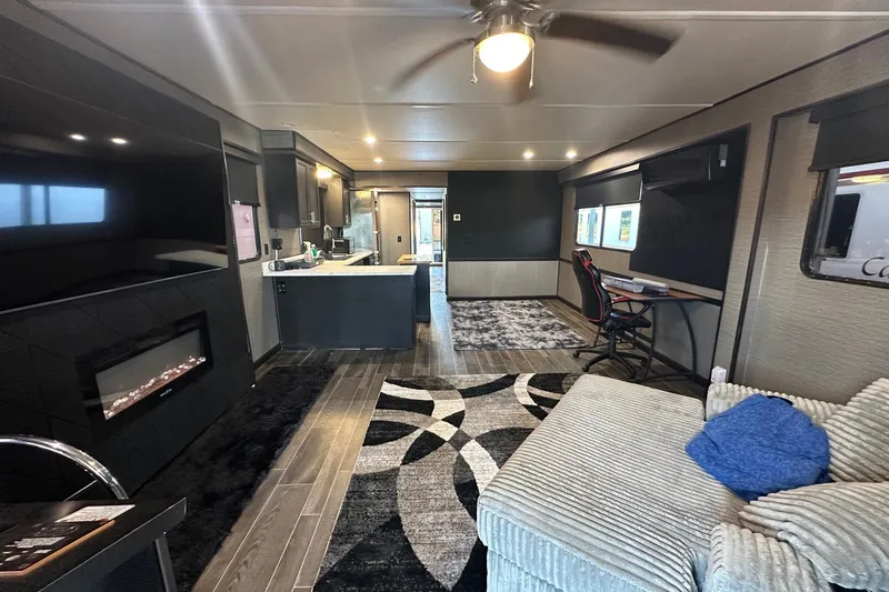 Slide: The Image of Luxurious interior of a 1988 Stardust Cruisers 16x65 houseboat with modern decor and fireplace. - 2