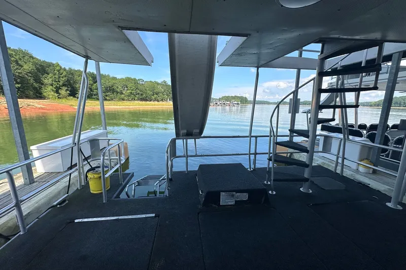 Slide: The Image of Interior view of 1988 Stardust Cruisers 16x65 houseboat on a serene lake. - 13