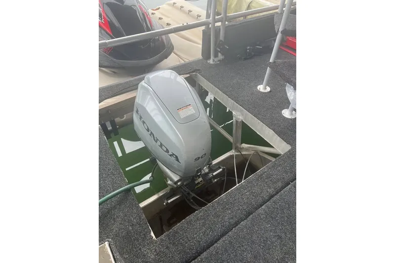 Slide: The Image of 1988 Stardust Cruisers 16x65 houseboat with Honda outboard motor installation. - 11