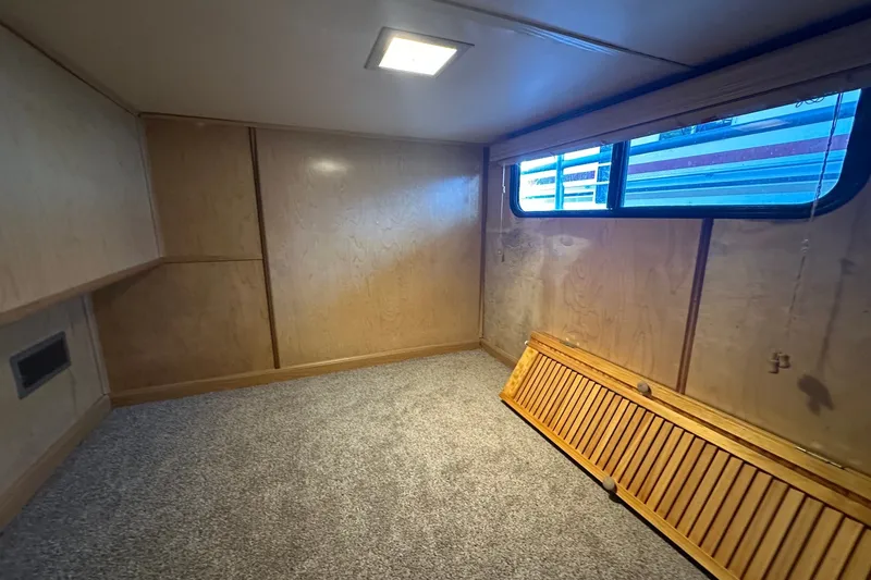 Slide: The Image of Interior of 1988 Stardust Cruisers 16x65 houseboat with wood paneling and carpeted floor. - 7