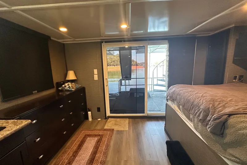 Slide: The Image of Interior of 1988 Stardust Cruisers 16x65 houseboat with modern furnishings and lake view. - 10