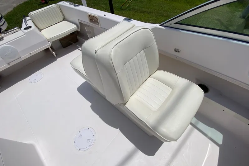 Slide: The Image of White seating area on a 1998 Grady-White Tournament 192 boat interior. - 12