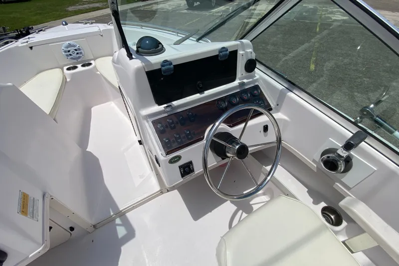 Slide: The Image of 1998 Grady-White Tournament 192 boat cockpit with steering wheel and control panel. - 9