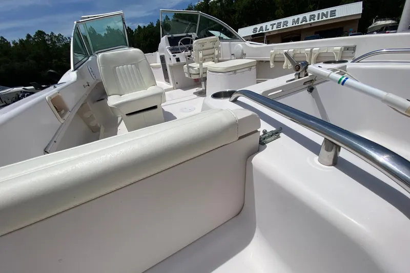 Slide: The Image of 1998 Grady-White Tournament 192 boat interior with white seating and steering console. - 7