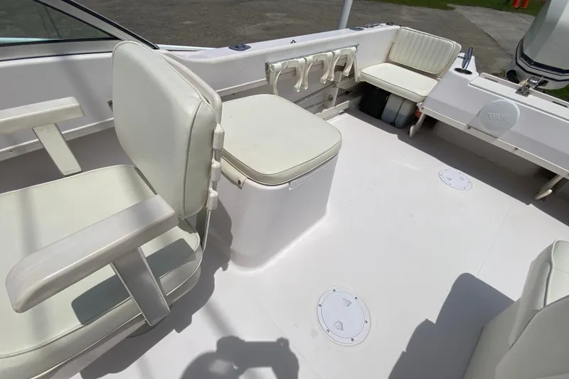 Slide: The Image of 1998 Grady-White Tournament 192 boat interior with white seating and fishing rod holders. - 13