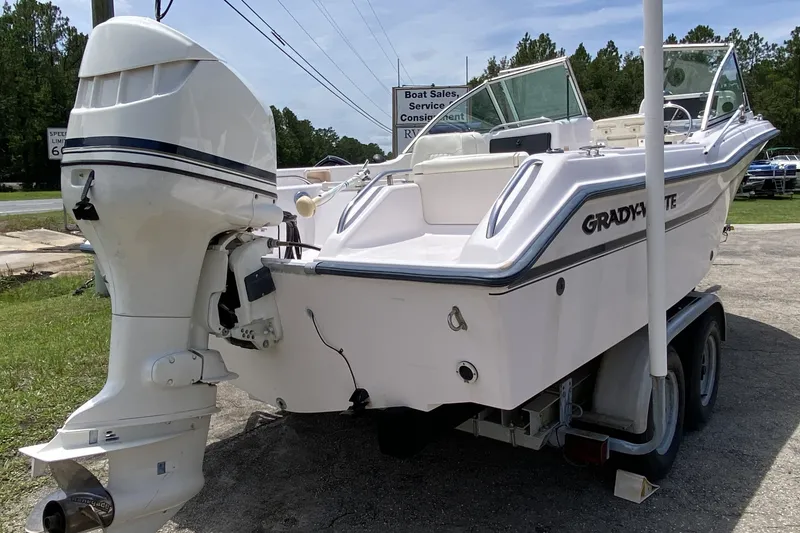 The Image of 1998 Grady-White Tournament 192 boat on trailer, featuring outboard motor. - 1