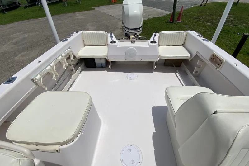 Slide: The Image of 1998 Grady-White Tournament 192 boat interior with white seating and motor. - 11