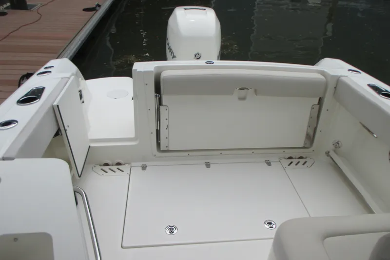 Slide: The Image of 2013 Boston Whaler 230 Vantage boat interior with seating and storage compartments. - 9