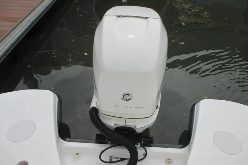 Slide: The Image of Boston Whaler 230 Vantage 2013 boat engine, docked on calm water. - 6