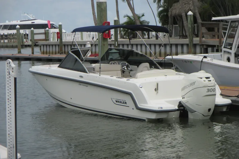 Slide: The Image of 2013 Boston Whaler 230 Vantage boat docked with Mercury 300 engine. - 2