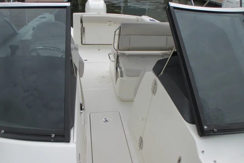 Slide: The Image of 2013 Boston Whaler 230 Vantage boat interior with seating and windshield. - 15