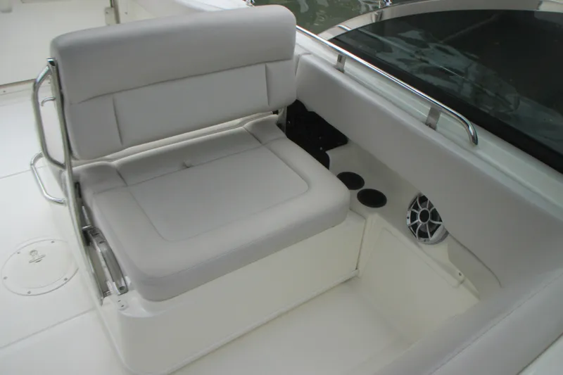 Slide: The Image of Boston Whaler 230 Vantage 2013 boat interior with cushioned seating and speaker. - 10