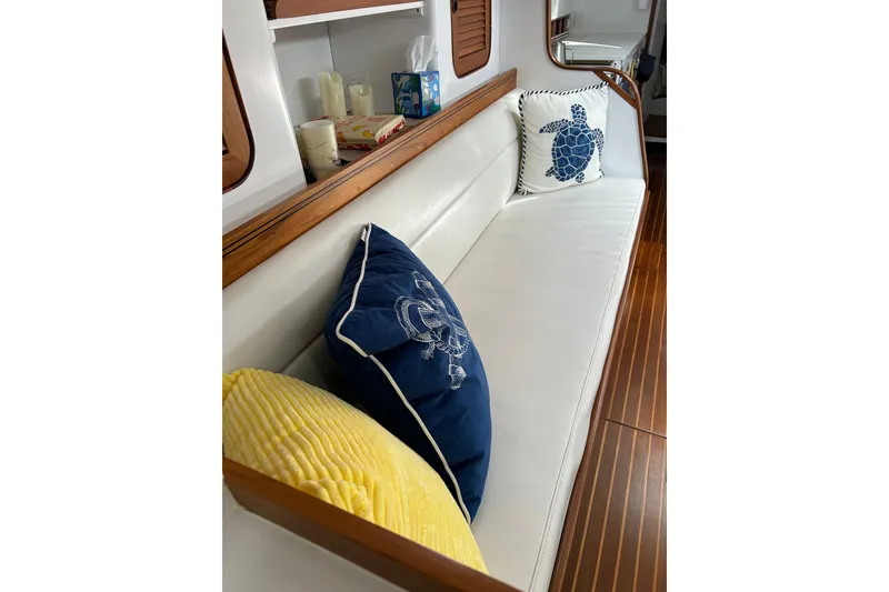 Slide: The Image of Interior of 1989 Hylas 44 yacht with decorative pillows on white seating. - 21