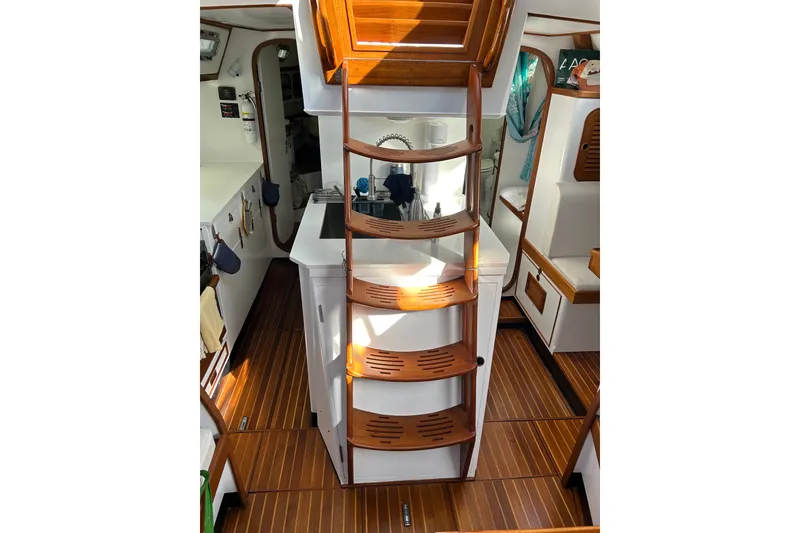 Slide: The Image of Interior of 1989 Hylas 44 sailboat with wooden steps and white cabinetry. - 16