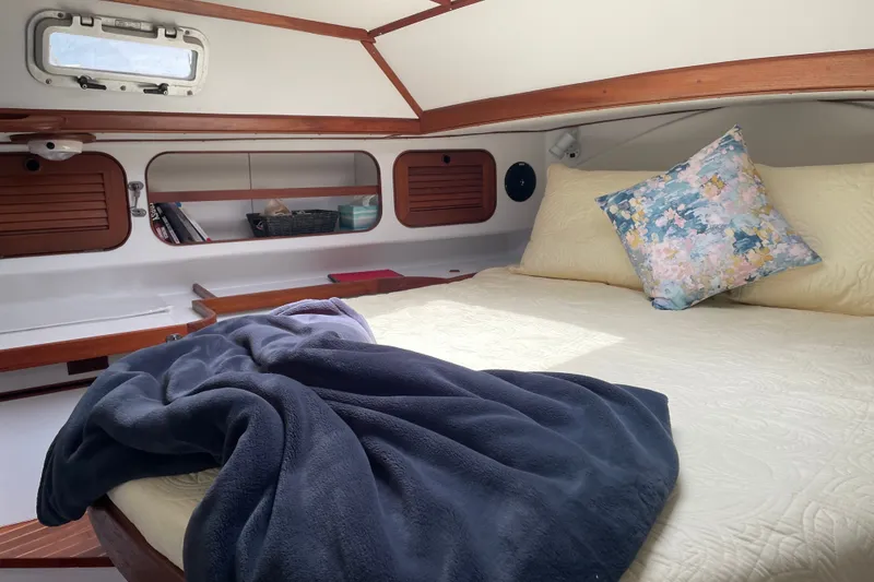 Slide: The Image of Cozy cabin interior of 1989 Hylas 44 yacht with bed, blanket, and floral pillow. - 30