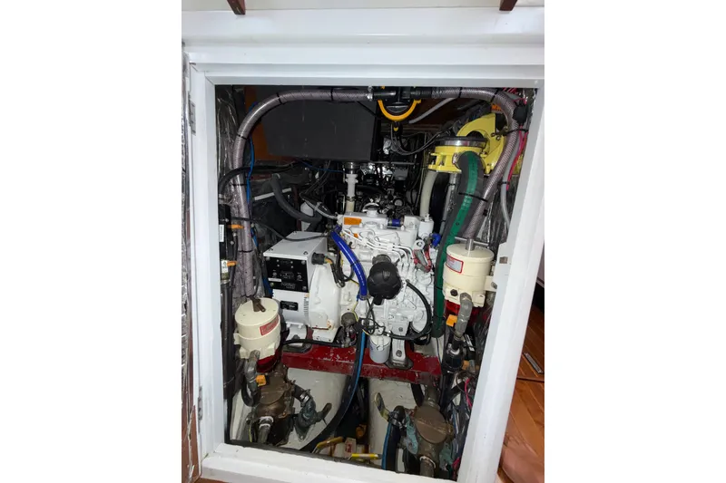 Slide: The Image of Engine compartment of a 1989 Hylas 44 yacht, showcasing mechanical components and wiring. - 44