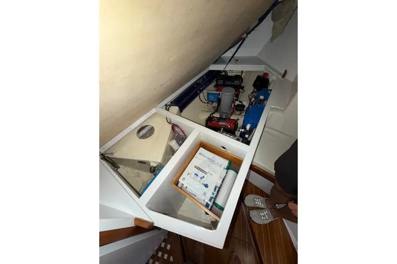 Slide: The Image of Interior view of a 1989 Hylas 44 yacht showing storage and equipment compartments. - 54