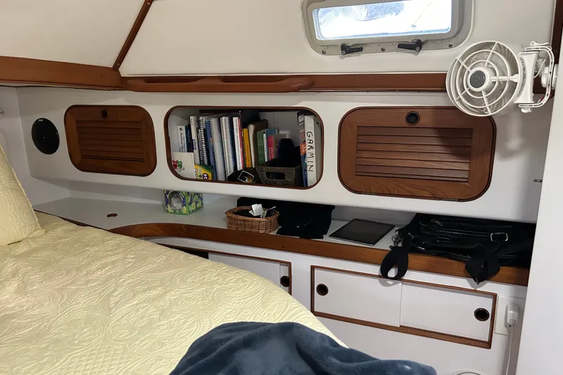 Slide: The Image of Cozy cabin interior of a 1989 Hylas 44 yacht with books and storage. - 33