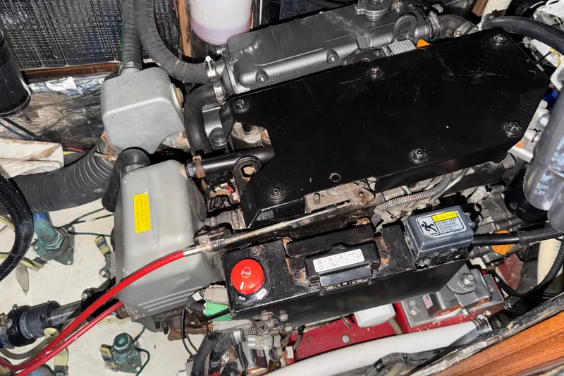 Slide: The Image of Engine compartment of a 1989 Hylas 44 sailboat, showcasing mechanical components and wiring. - 47