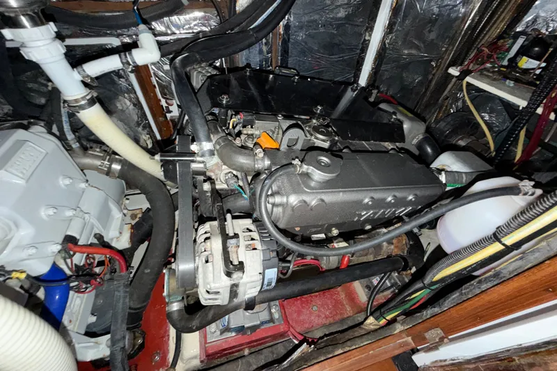 Slide: The Image of Engine compartment of a 1989 Hylas 44 yacht, showcasing mechanical components and wiring. - 46