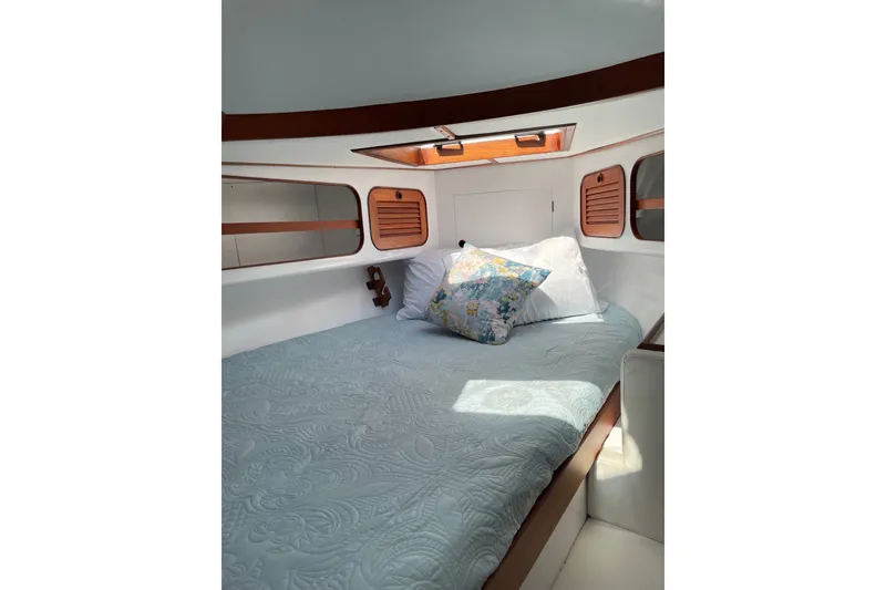Slide: The Image of Cozy cabin interior of 1989 Hylas 44 yacht with bed and decorative pillows. - 39