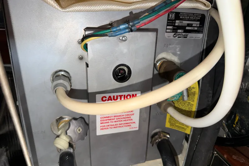 Slide: The Image of Water heater connections and caution label on a 1989 Hylas 44. - 50