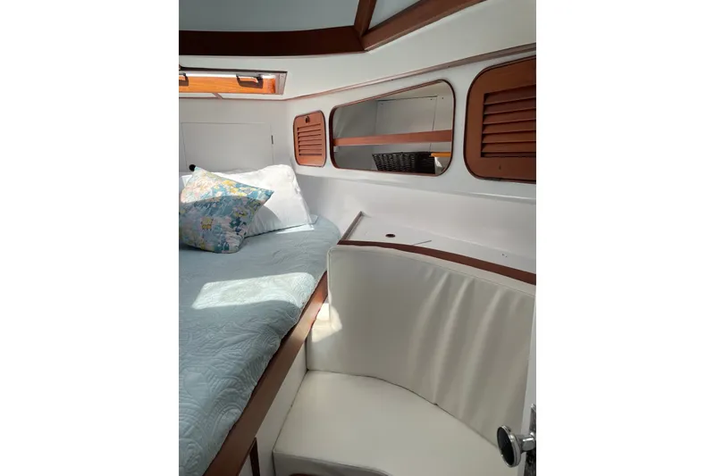 Slide: The Image of Cozy cabin interior of 1989 Hylas 44 yacht with bed and wooden accents. - 41