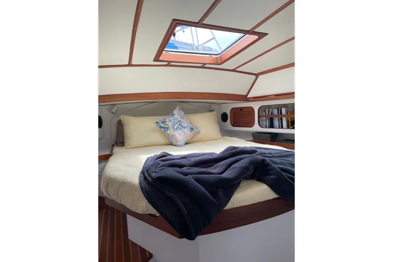 Slide: The Image of Cozy cabin interior of 1989 Hylas 44 sailboat with skylight and plush bedding. - 31