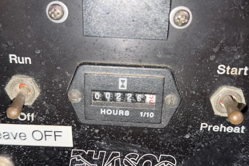 Slide: The Image of Control panel of a 1989 Hylas 44 with hour meter and toggle switches. - 43