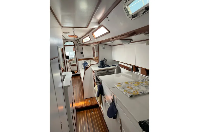 Slide: The Image of Interior of 1989 Hylas 44 yacht with sleek wood flooring and modern kitchen amenities. - 25