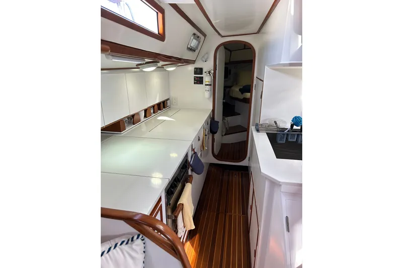 Slide: The Image of Interior of 1989 Hylas 44 yacht featuring sleek kitchen and wooden flooring. - 27