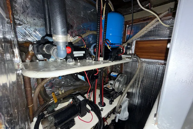 Slide: The Image of Engine room of a 1989 Hylas 44 yacht, showcasing mechanical components and wiring. - 45