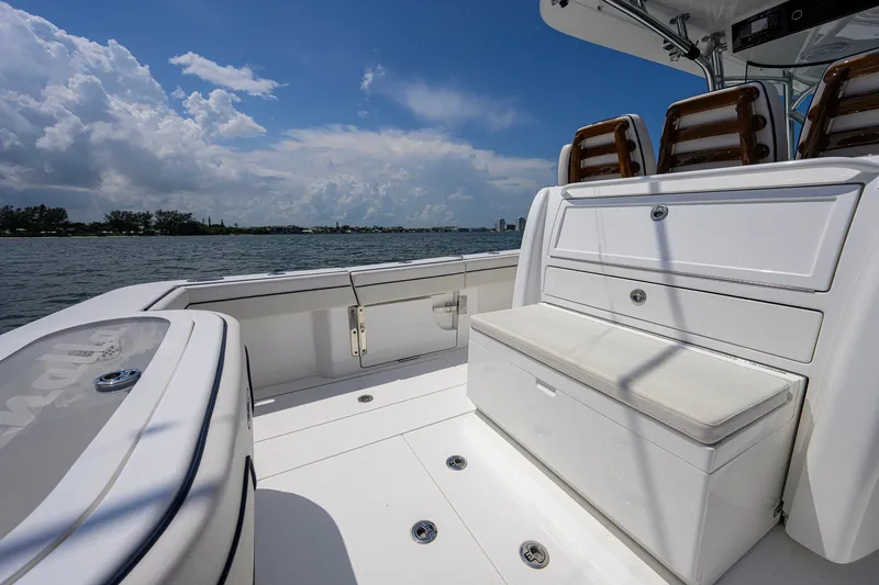 Slide: The Image of 2025 Valhalla Boatworks V-33 deck with seating, storage, and ocean view under blue sky. - 47