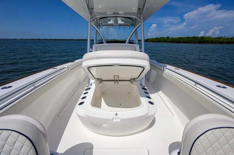 Slide: The Image of 2025 Valhalla Boatworks V-33 center console with open storage, on calm water. - 40