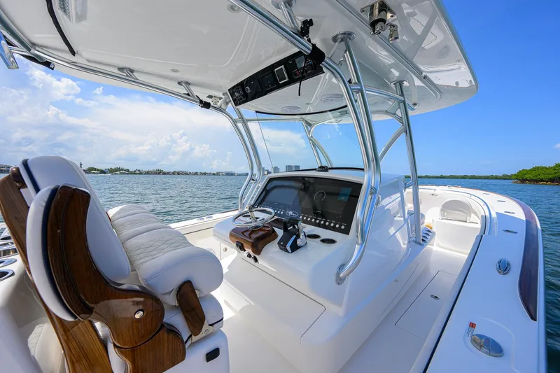 Slide: The Image of 2025 Valhalla Boatworks V-33 helm with luxurious seating and advanced controls on open water. - 24