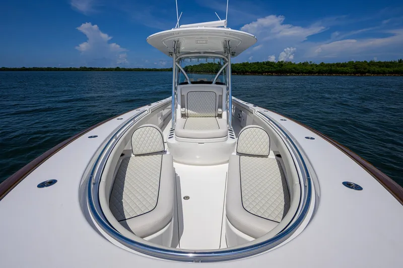 Slide: The Image of 2025 Valhalla Boatworks V-33, luxurious seating, open water, clear sky, elegant design. - 37