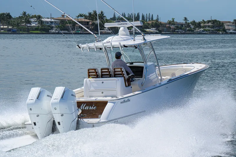 Slide: The Image of 2025 Valhalla Boatworks V-33 cruising on water with twin engines, scenic background. - 16