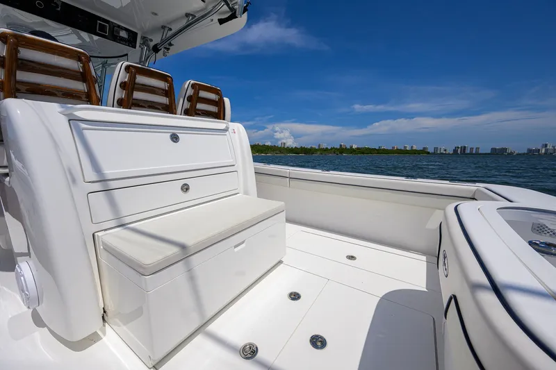 Slide: The Image of 2025 Valhalla Boatworks V-33 interior with seating, ocean view, and clear blue sky. - 48