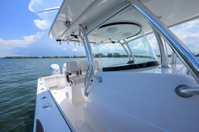 Slide: The Image of 2025 Valhalla Boatworks V-33 on water, showcasing sleek design and spacious deck. - 26